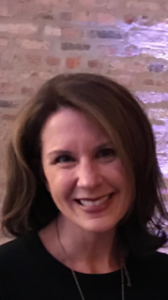 Photo of Mary in front of a brick wall